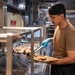 Culinary specialists prepare food for Sailors