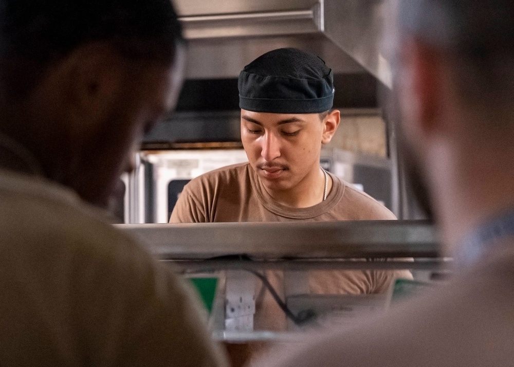 Culinary specialists prepare food for Sailors