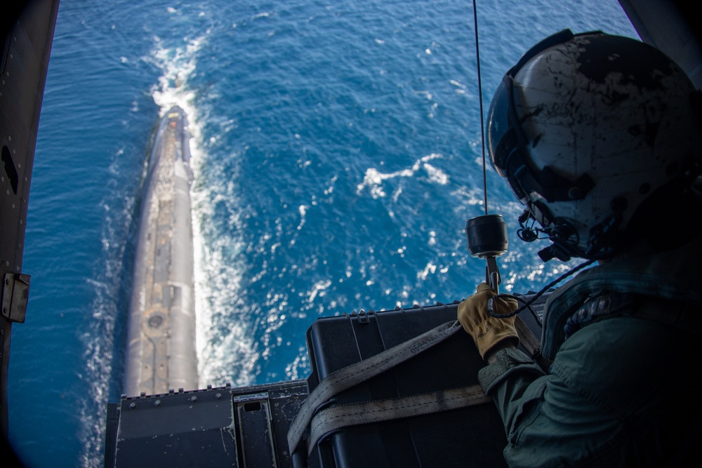 U.S. Marine Corps MV-22B Osprey resupplies U.S. Navy submarine