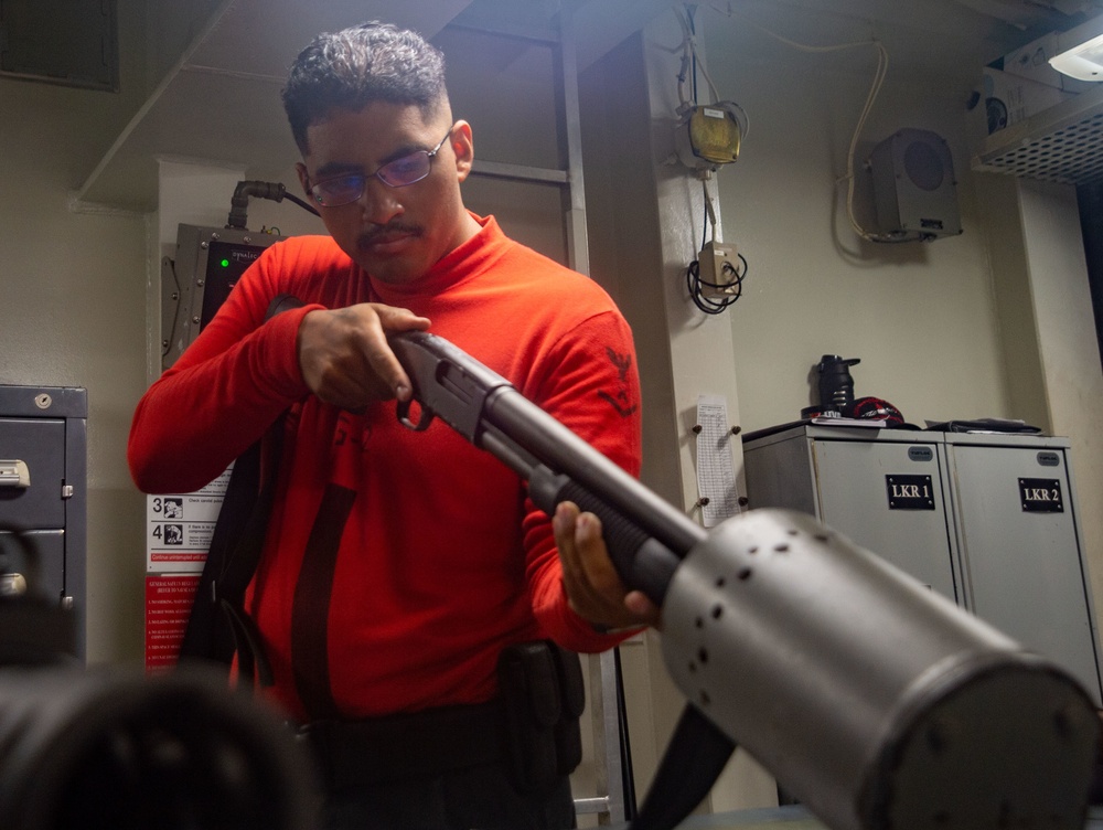 USS Ronald Reagan Sailors maintain weapons in armory