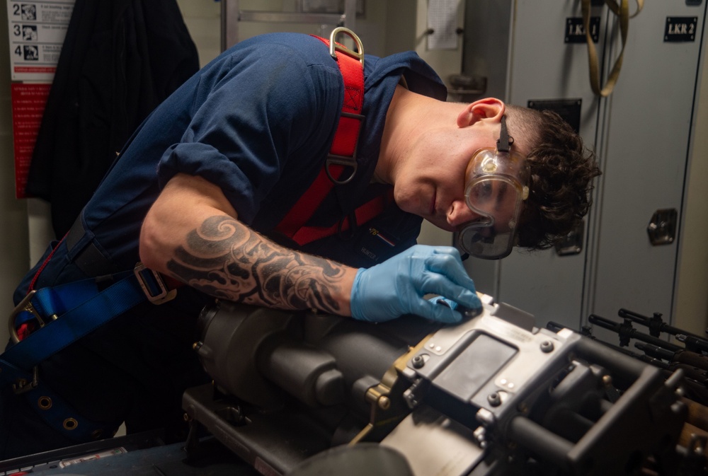 USS Ronald Reagan Sailors maintain weapons in armory