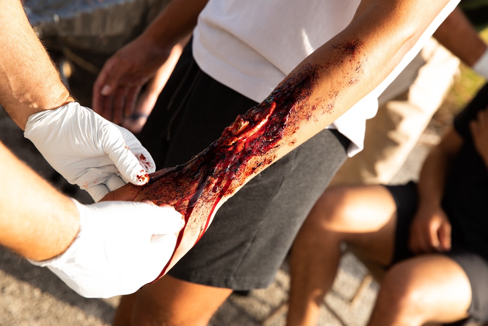 Civilian role players receive simulated injuries before seeking medical attention