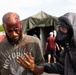 140th Chemical Company Soldier assists volunteer in the decontamination line