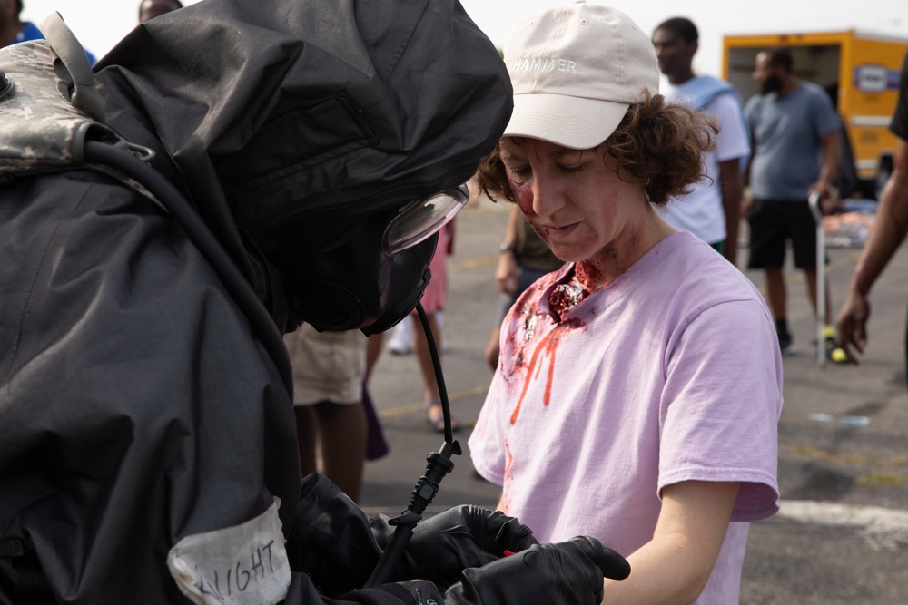 140th Chemical Company Soldier attaches injury category marker to a notionally injured civilian role player