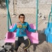 A child enjoys playground equipment in Al Shouhada, Yemen