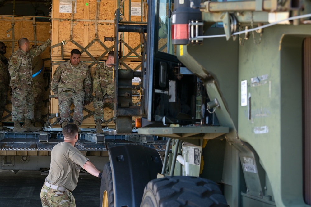 621st CRW offloads cargo being transferred to 156th CRG