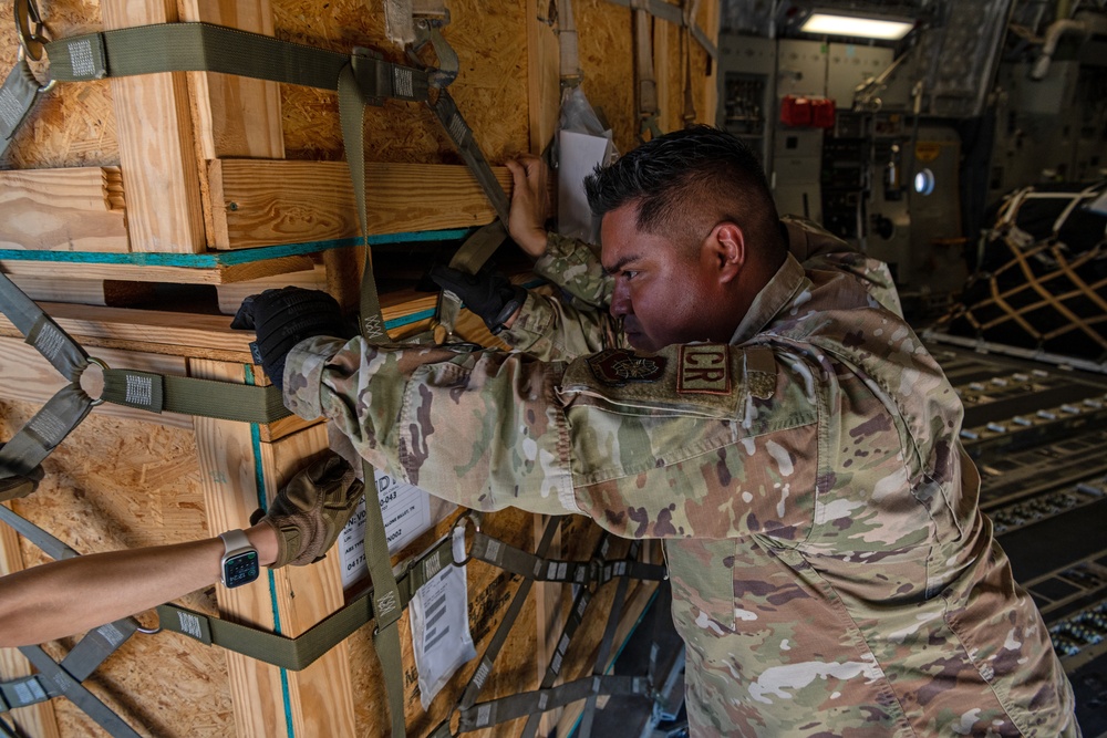 621st CRW offloads cargo being transferred to 156th CRG