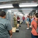 Tech. Sgt. John Brown shares information about the Modular Containerized Small Arms Training Set (MCSATS) facility (indoor shooting range) during a base tour on Aug. 1, 2022