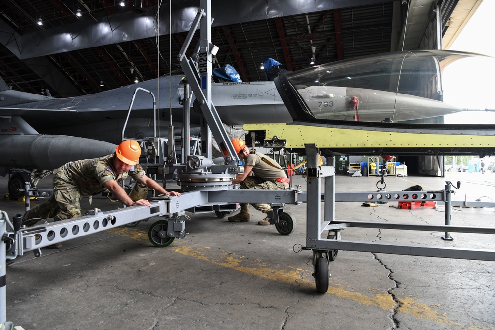 Multicapable Wolf Pack personnel perform an F-16 Fighter Falcon canopy replacement during RF-A 22-3