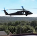 Scouts from the 1/110th Infantry Regiment rappel from a UH-60 Black Hawk during a live fire training exercise.