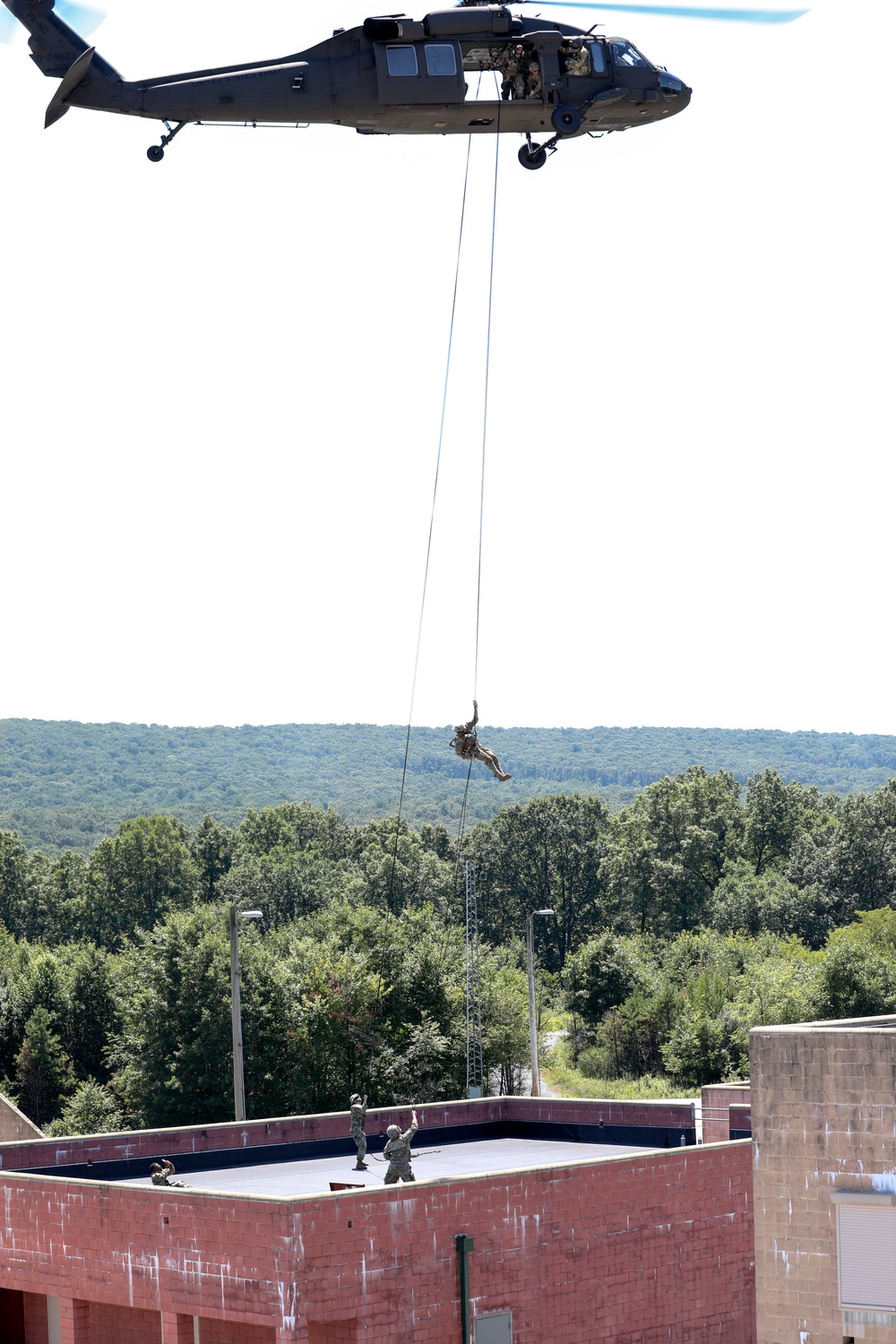 Scouts from the 1/110th Infantry Regiment rappel from a UH-60 Black Hawk during a live fire training exercise.