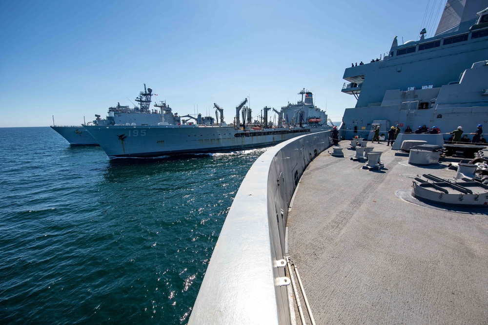 USS Arlington and USS Gunston Hall replenish simultaneously at sea