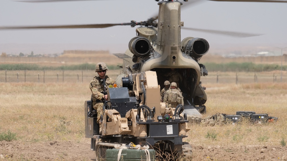 Soldier drives SCAMP at training cite with Chinook