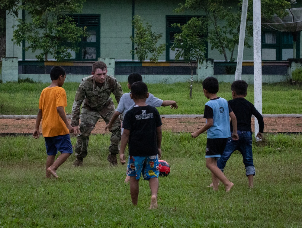 Soldiers Play Soccer with Local Children during Super Garuda Shield