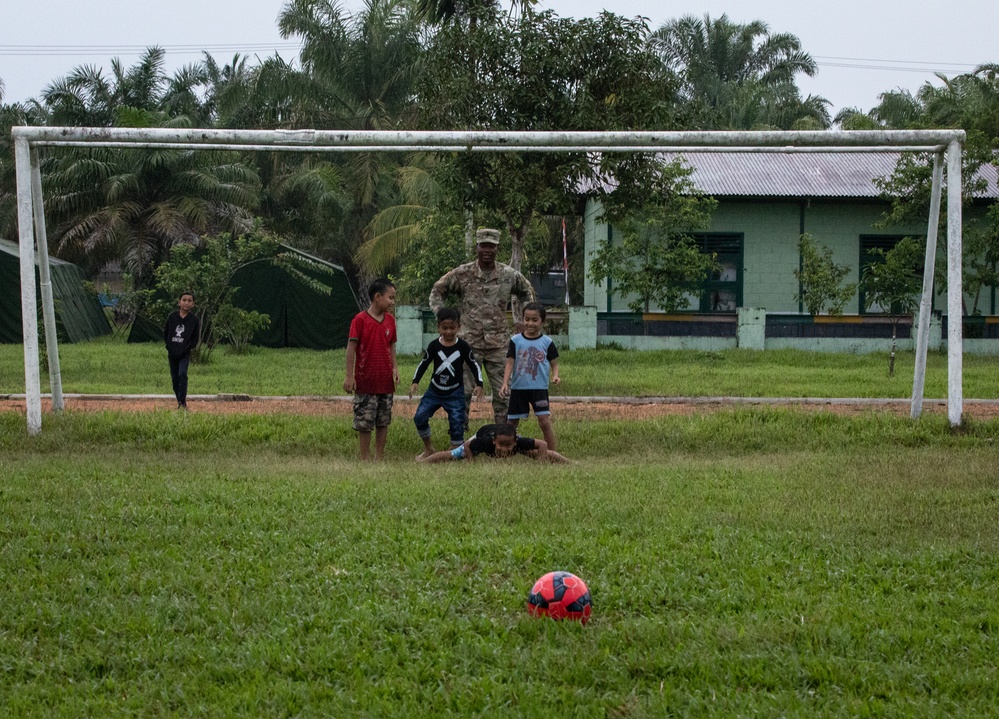 Soldiers Play Soccer with Local Children during Super Garuda Shield