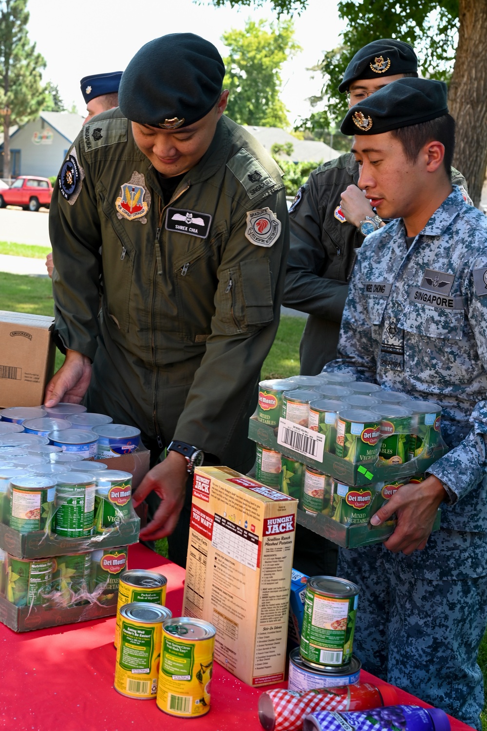 428th Fighter Squadron, RSAF members donate food to community