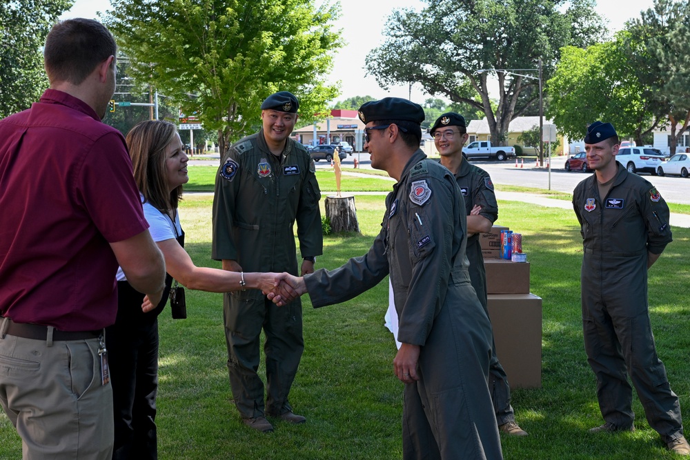 428th Fighter Squadron, RSAF members donate food to community