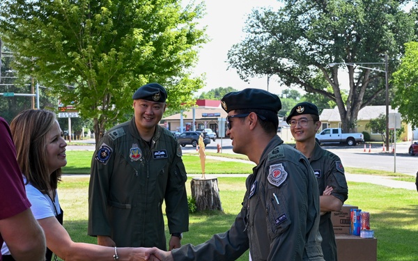 428th Fighter Squadron, RSAF members donate food to community