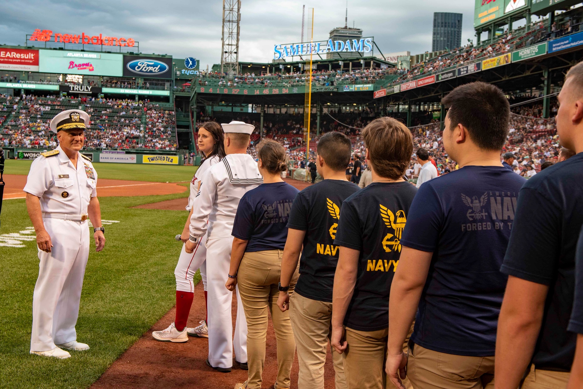 U.S. Navy Sailors take to the field prior to the singing of the