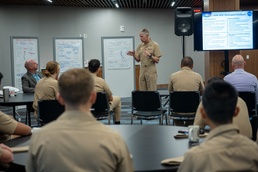 Chief of Naval Research Rear Adm. Lorin Selby speaks to recent Naval Academy graduates at the SCOUT "design thinking" event.