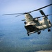 CH-47 hovers over drop zone