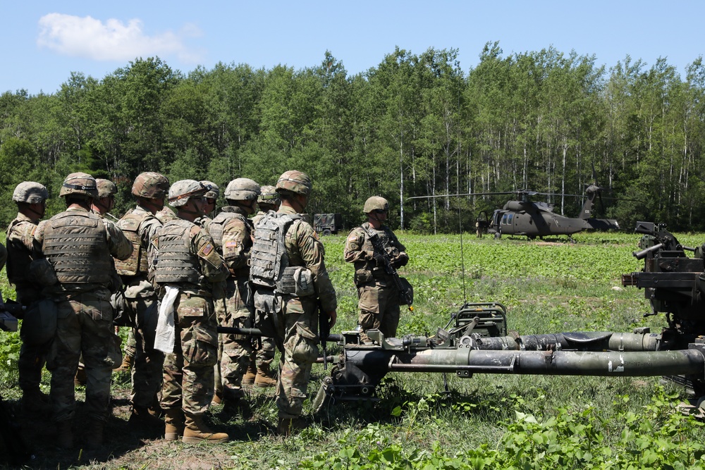 U.S. Army Soldiers, 1-134th Field Artillery Regiment, watch UH-60 Blackhawks land during Northern Strike 22-2