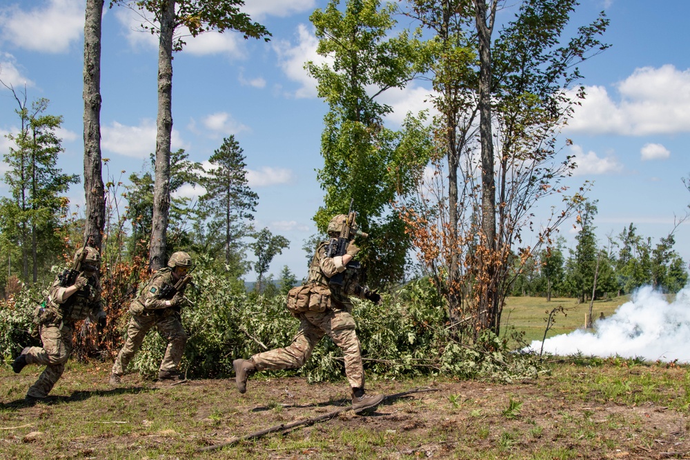 British Army 7 Rifles sprint toward smoke grenade cover at Northern Strike