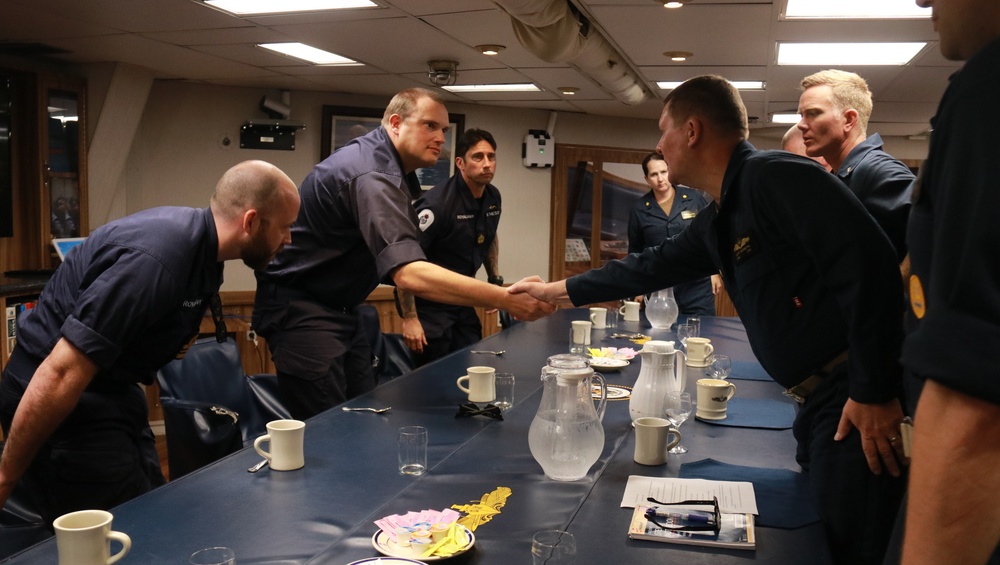 Rear Adm. Scott Sciretta, Commander, Standing NATO Maritime Group Two (SNMG2), conducts a meeting with the leadership from Royal Navy submarine Audacious
