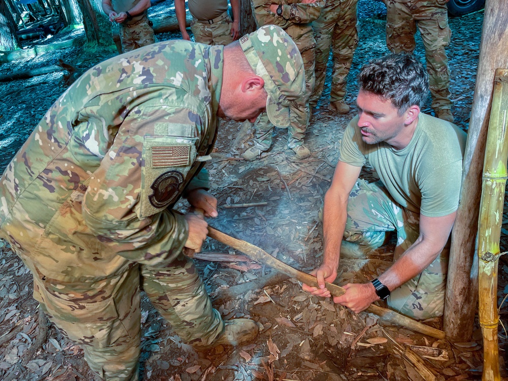 Airmen learn to start a fire with rudimentary tools