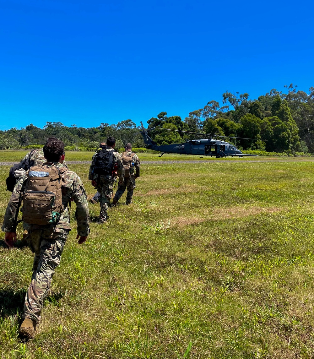 Airmen approach an HH-60G Pave Hawk helicopter