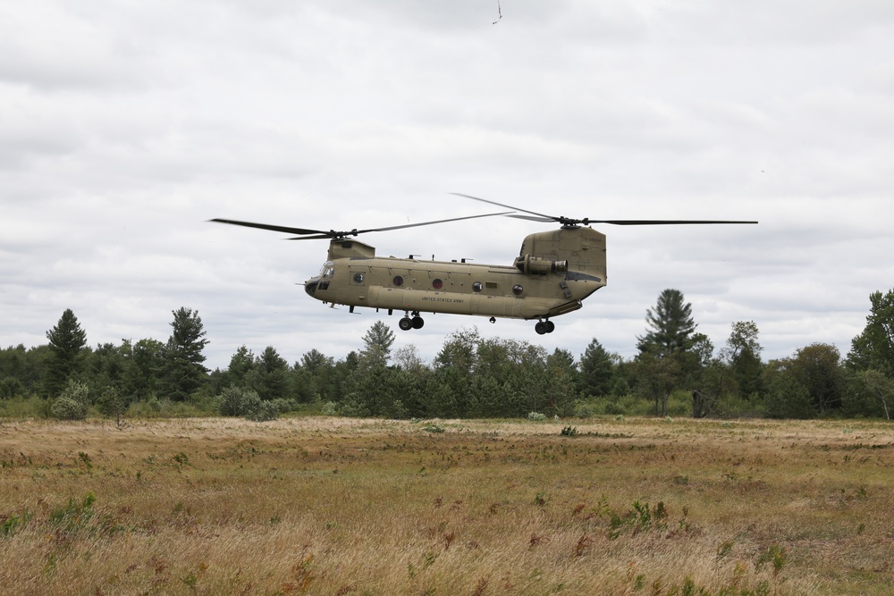 CH-47 chinook takes off from a field during Northern Strike 22