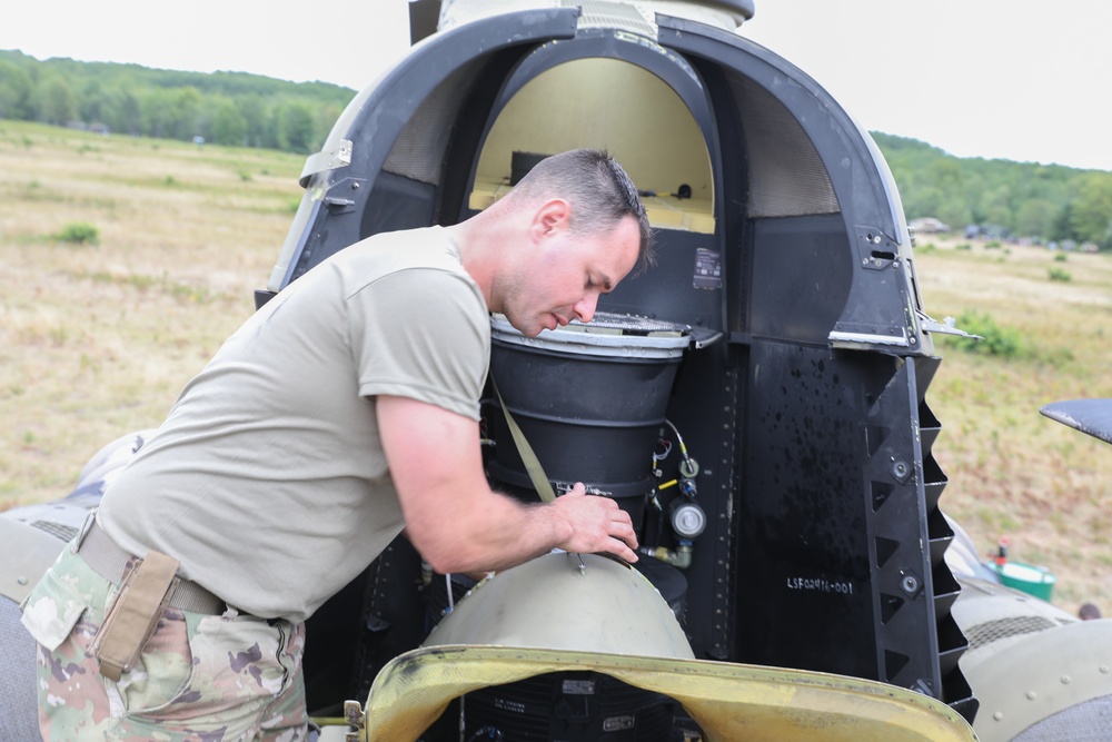 Chinook mechanic works on a CH-47 chinook