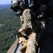 US Army helicopter crewmember looks out over the drop zone