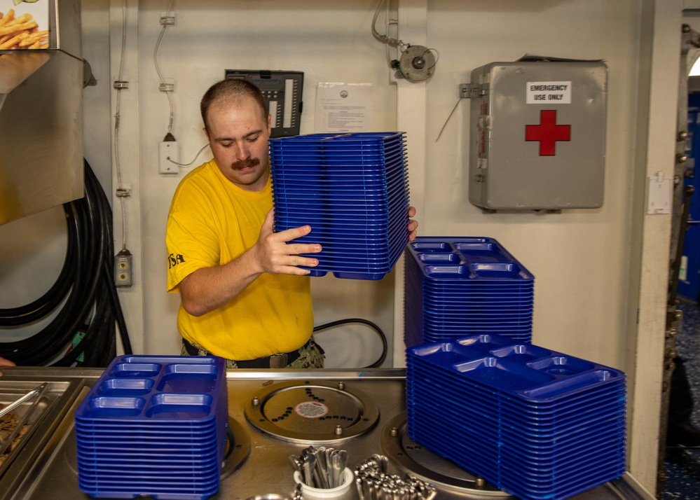 Sailor cleans dishes