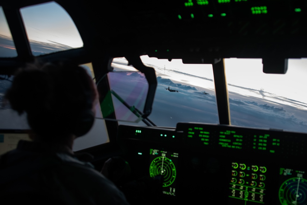 MC-130J Commando IIs conduct nighttime three-ship formation operations