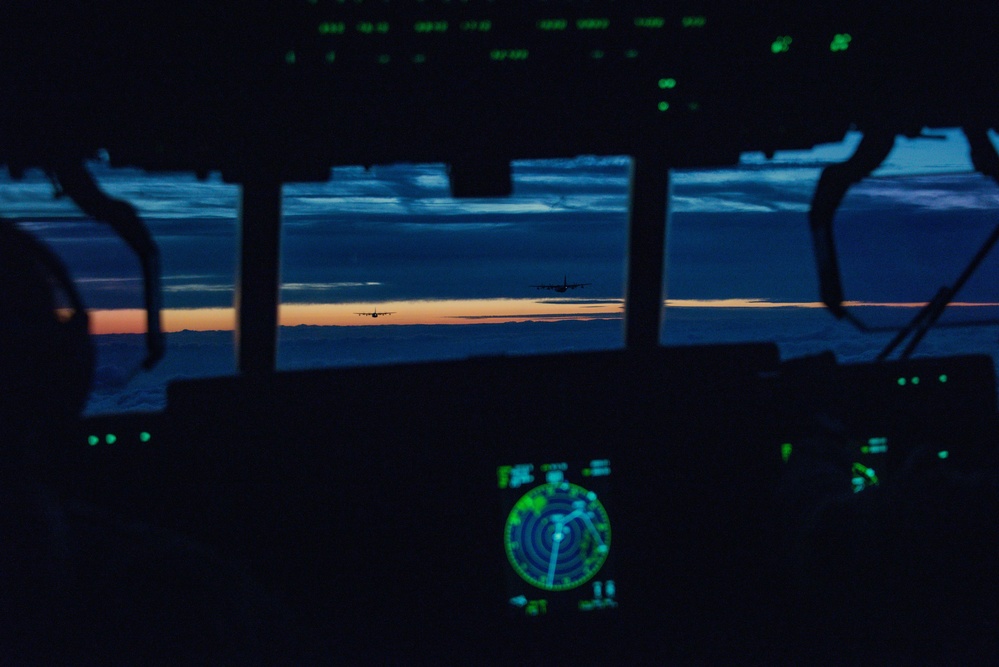 MC-130J Commando IIs conduct nighttime three-ship formation operations