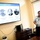 A military officer in a light blue uniform is presenting a historical briefing in a conference room. The presentation slide, displayed on a large wall-mounted TV, is in Spanish and titled 'Fundado en 1962,' covering the founding history of an organization called CID (Inter-American Defense College). The slide includes a timeline with dates from March to October 1962 and circular portrait photographs of historical figures.