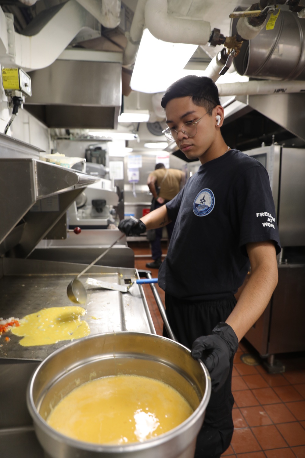 USS George H.W. Bush (CVN 77) Sailor cooks for the crew.