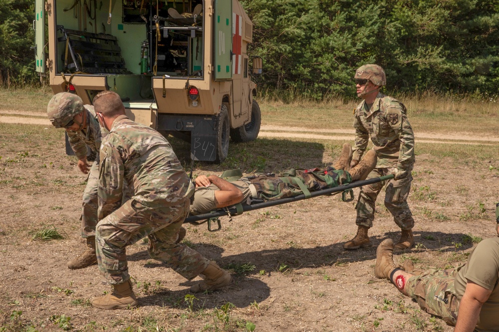 1171st Medical Company Area Support Lift a Roleplaying Patient onto a Litter During Northern Strike 22-2