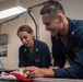 USS Ronald Reagan (CVN 76) Sailors pack and prepare parachutes