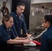 USS Ronald Reagan (CVN 76) Sailors pack and prepare parachutes