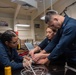 USS Ronald Reagan (CVN 76) Sailors pack and prepare parachutes