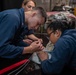 USS Ronald Reagan (CVN 76) Sailors pack and prepare parachutes