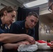 USS Ronald Reagan (CVN 76) Sailors pack and prepare parachutes