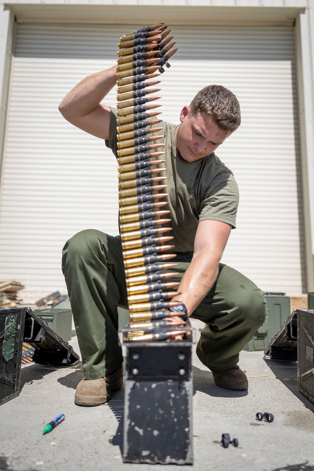 Marines with Marine Heavy Helicopter Squadron (HMH) 461 prepare ammo