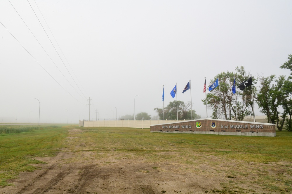 Heavy fog covers a sign at the front of the base entrance at Minot Air Force Base