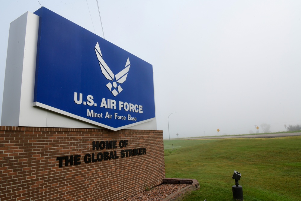 Heavy fog covers a sign at the front of the base entrance at Minot Air Force Base