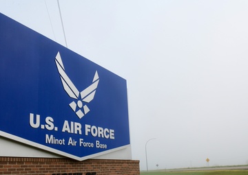 Heavy fog covers a sign at the front of the base entrance at Minot Air Force Base