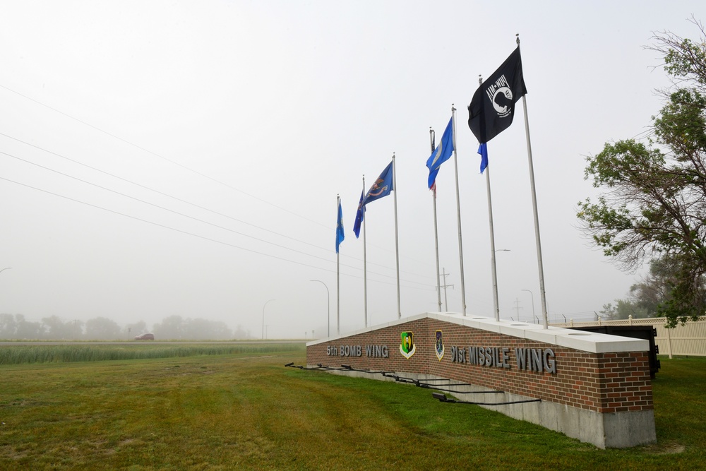 Heavy fog covers a sign at the front of the base entrance at Minot Air Force Base