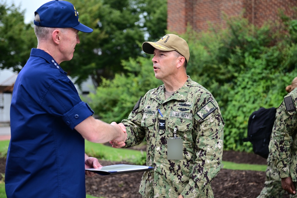 Coast Guard Vice Adm. presents the Coast Guard Special Operations Service Ribbon to crew of USS Hershel “Woody” Williams